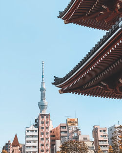 Low angle view of temple building against sky and tokyo sky tree in the background 