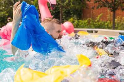 People holding multi colored water