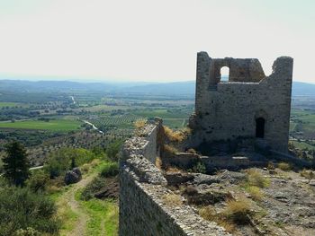 Built structure on landscape against the sky