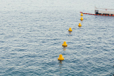 High angle view of buoys floating on sea