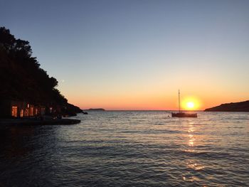 Scenic view of sea against clear sky during sunset