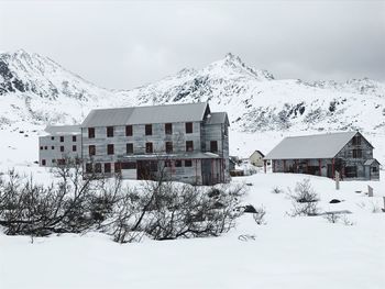 Snow covered houses against sky