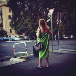 Rear view of woman standing on street