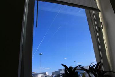 Low angle view of blue sky seen through window