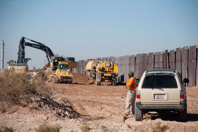 Man at construction site against clear sky