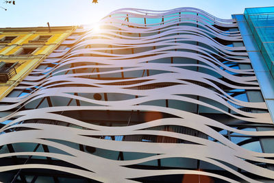 Low angle view of modern building against blue sky