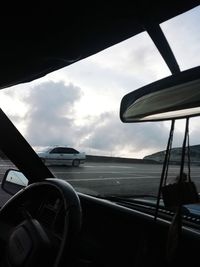 Car against sky seen through windshield window