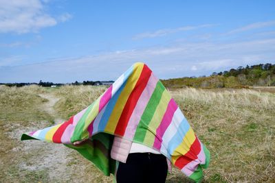 Person standing on field against sky