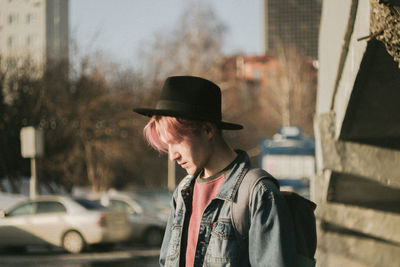 Midsection of man wearing hat standing in city