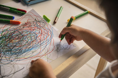 Cropped hands of person working on table