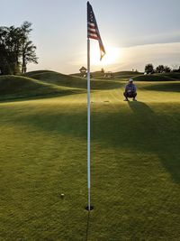 Flag with man on golf course