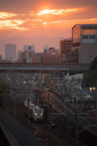 Railroad tracks against sky during sunset