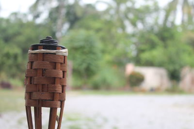 Close-up of wicker basket on field