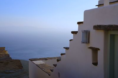 Scenic view of sea and buildings against clear sky