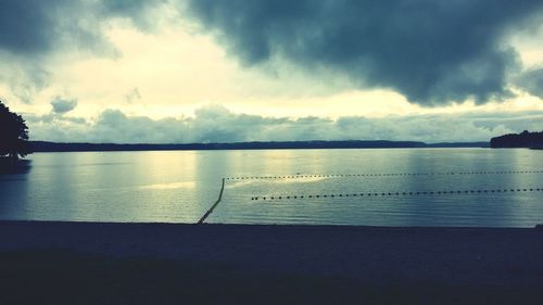 Scenic view of lake against cloudy sky