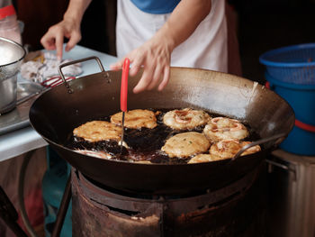 Midsection of man preparing food