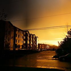 Buildings in city at sunset