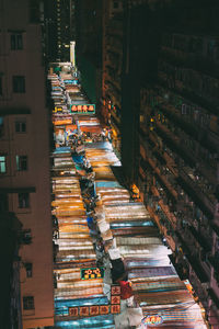 High angle view of illuminated street market amidst buildings