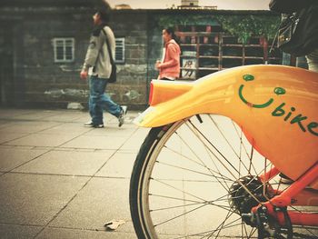 Man cycling on yellow bicycle in city