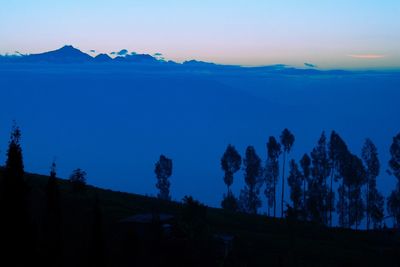 Scenic view of mountains against blue sky