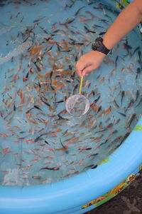 Cropped hand fishing outdoors