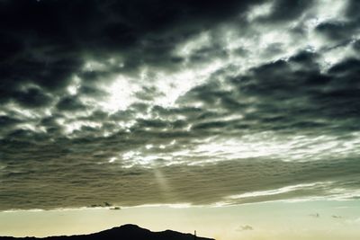 Scenic view of sea against storm clouds