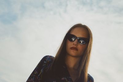 Portrait of woman wearing sunglasses against sky