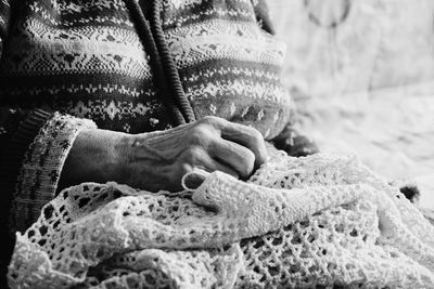 Midsection of woman knitting wool