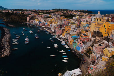 High angle view of townscape by sea against sky