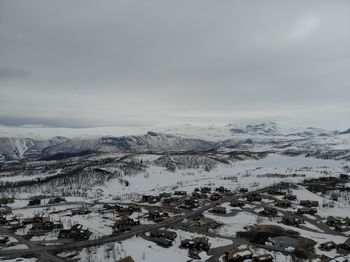 Scenic view of snow covered mountains against sky