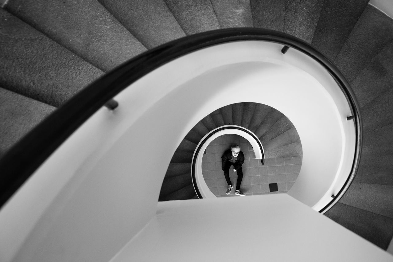 steps and staircases, staircase, steps, architecture, one person, built structure, indoors, real people, tunnel, full length, spiral, stairs, lifestyles, women, spiral staircase, hand rail, day, young adult, people