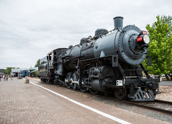 Train on railroad tracks against sky