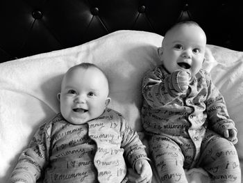 High angle view of twin baby boys relaxing on bed at home