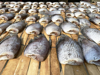 Dried snakeskin gourami placed on a table for sale. it is a popular food preservation in thailand.