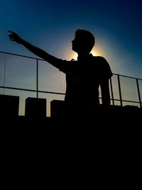Low angle view of silhouette people against sky