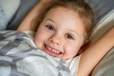 Portrait of cute girl sleeping on bed at home