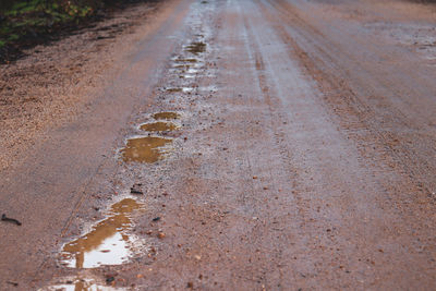 High angle view of wet road in puddle