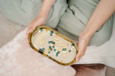 High angle view of woman hand on bed at home