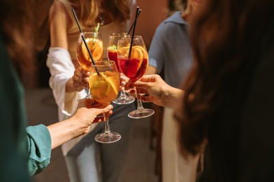 Girlfriends proposing toast on summer party.