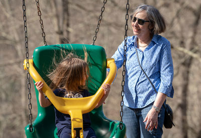 Girl with grandmother on swing