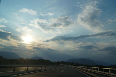 Highway against sky during sunset