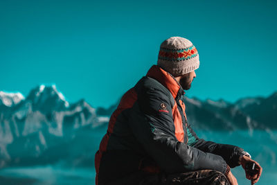 Full length of young man looking away on snow