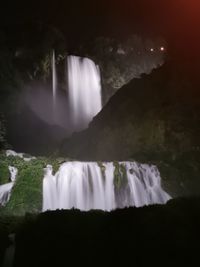 Scenic view of waterfall against sky