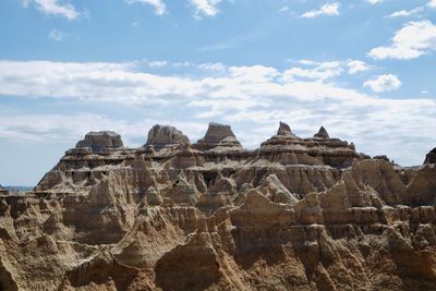 Low angle view of rock formations against sky