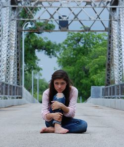 Portrait of smiling young woman sitting outdoors