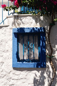 Close-up of painting on blue wall against building