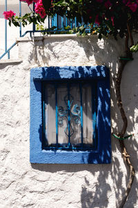 Close-up of painting on blue wall against building