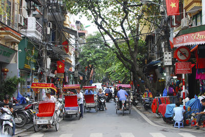 People and rickshaws on hanoi street