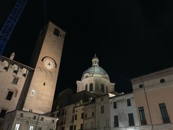 Low angle view of buildings against sky at night