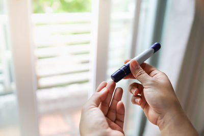 Close-up of woman hand holding cigarette